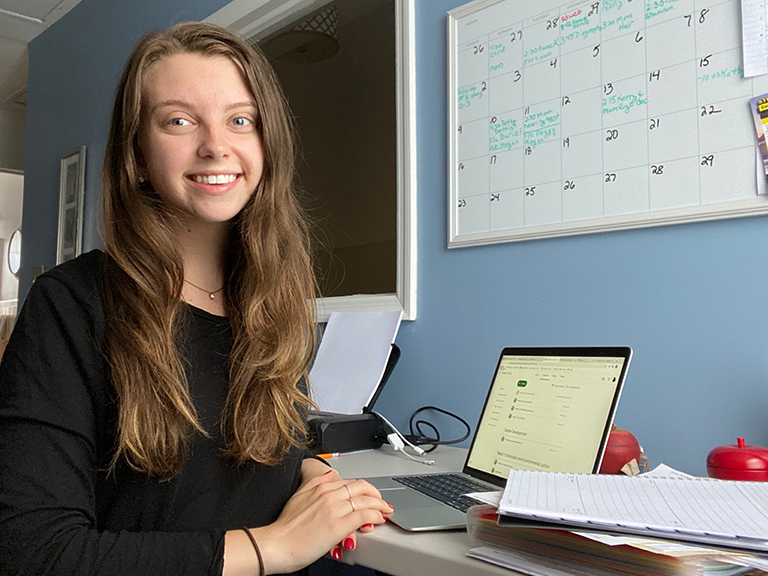 Patricia smiling from her desk 